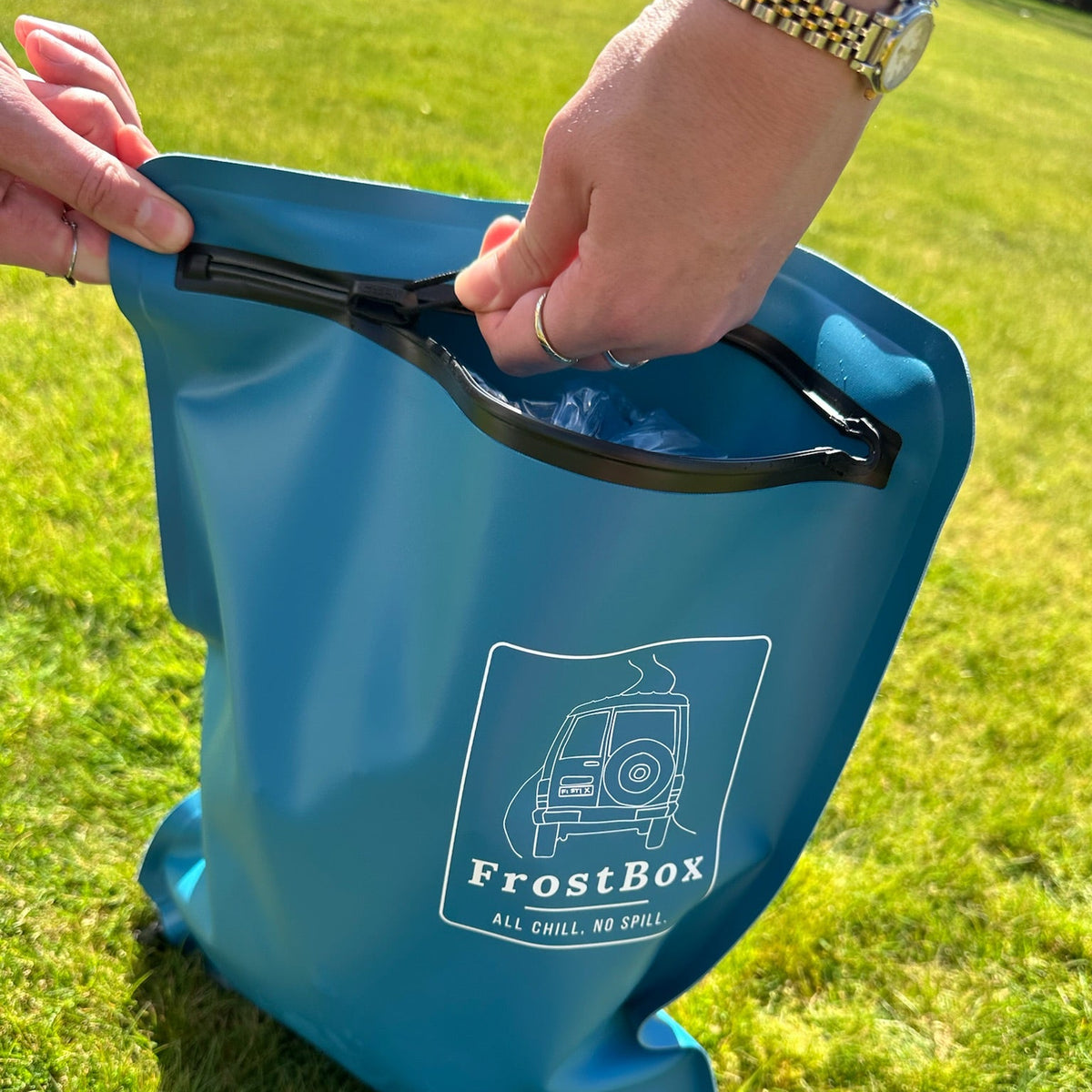 Hands opening the TRU® Zip on a Tasman Blue FrostBox to fill it with ice